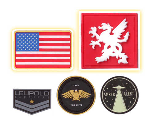 PVC patches that feature an American flag, The Elites (1984), a spaceship, and Leupold Tactical